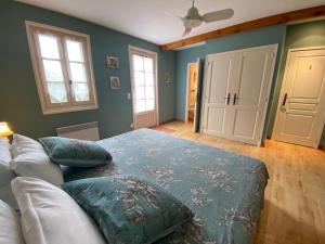 a living room with a couch and two pillows at Petit Rousset Gite Cerise in Eymet +23 photos