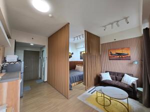 a living room with a couch and a bed at The Beacon Haven in Trece Martires