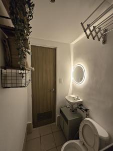 a bathroom with a toilet and a sink at The Beacon Haven in Trece Martires +14 photos
