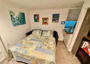 a bedroom with a bed and paintings on the wall at Artsy Platt Park Apartment Guest Suite for 4, QUICK Mountain Access! in Denver