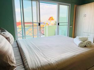 a bedroom with a large bed with towels on it at Dancenter Bupatara Chiangmai in Chiang Mai +27 photos
