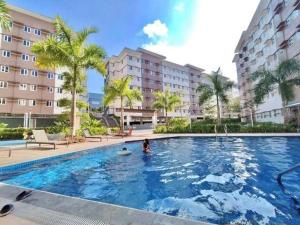 a person in a swimming pool in a hotel at The Beacon Haven in Trece Martires
