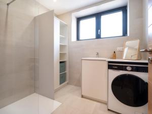 a bathroom with a washing machine and a shower at La Ferme d'Estelle in Vulmont +124 photos