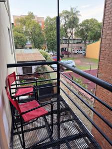two chairs sitting on the balcony of a building at Hermoso Depto en ELDORADO in Eldorado