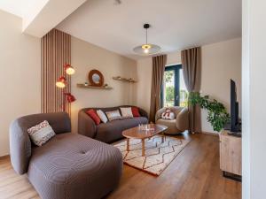 a living room with a couch and a table at La Ferme d'Estelle in Vulmont