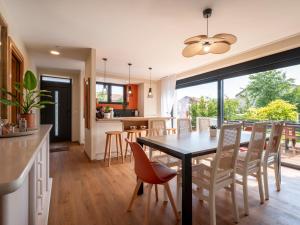 a kitchen and dining room with a table and chairs at La Ferme d'Estelle in Vulmont