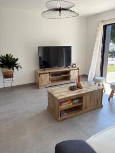 a living room with a flat screen tv at Maison neuve cosy à 20 min des plages #lorient #cosy in Pont-Scorff