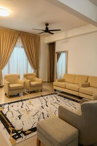 a living room with couches and a rug at SAMPOISGT VILLA HOMESTAY - 3 Bedroom Landed House - Near Bangi Avenue, BACC, Bangi Wonderland, UKM, GMI, EVO, Bangi Gateway, KIPMall in Kajang
