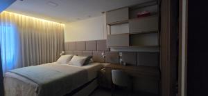 a hotel room with a bed and a desk and a bed sidx sidx sidx sidx at Belém COP30 Apartment in Belém +35 photos