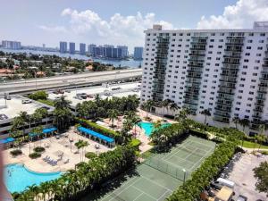 an aerial view of a tennis court in front of a building at Ocean reserve 2 bedroom plus den in Sunny Isles Beach