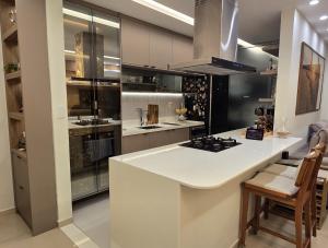 a kitchen with a white counter top and a stove at Belém COP30 Apartment in Belém