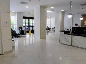 a large white lobby with a counter in a building at Ocean reserve 2 bedroom plus den in Sunny Isles Beach +55 photos