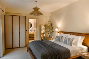 a bedroom with a large bed and a bathroom at The Attican Villa & Estate in Anavissos
