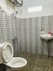 a bathroom with a toilet and a sink at Omah Eitan in Wonosari
