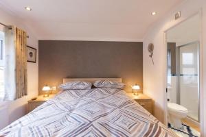1 dormitorio con 1 cama con 2 lámparas y aseo en The South Vista, en Swarland