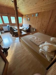 a large bed in a room with wooden walls at PusztaHaus Pusztavám in Mór