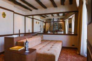 a living room with a couch and a table at Hôtel Confidentiel - Louvre in Paris +39 photos