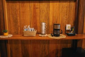 a wooden shelf with a coffee maker on it at Bolontikú in Bacalar