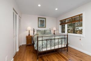 a bedroom with a bed and two windows at Ledges 78 with Wintergreen Advantage in Wintergreen