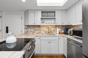 a kitchen with white cabinets and a sink at Ledges 78 with Wintergreen Advantage in Wintergreen
