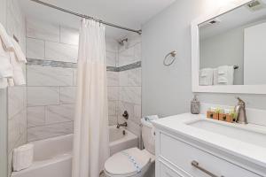 a white bathroom with a toilet and a sink at Ledges 78 with Wintergreen Advantage in Wintergreen +9 photos