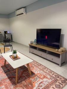 a living room with a large flat screen tv at شقق العليا الفندقية VIP - luxury in Al Khobar