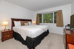 a bedroom with a large bed and a window at Ledges 72 with Wintergreen Advantage in Wintergreen