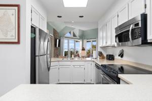 a kitchen with white cabinets and stainless steel appliances at Shenandoah Ridge 05 with Wintergreen Advantage in Wintergreen