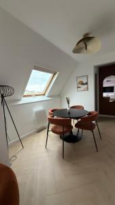 a room with a table and chairs and a window at Apartment Orléans in Orléans