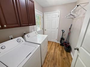 a white laundry room with a washer and dryer at Cozy 2 Bedroom Townhouse Near Lake and Restaurants in Guntersville +10 photos