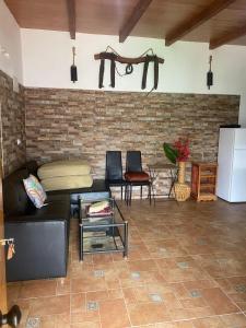 a living room with a couch and a brick wall at house carmen in Villaminaya