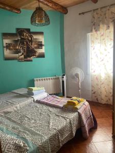 a bedroom with a bed in a room with green walls at house carmen in Villaminaya +5 photos