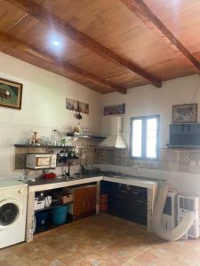 a kitchen with a sink and a washing machine at house carmen in Villaminaya