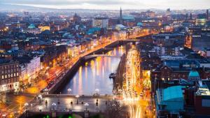 a city with a bridge over a river at night at One Bedroom Site Apartment in Dublin