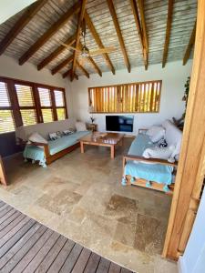a living room with a couch and a table at Vanille et Vahiné FR2PF8AL in Grand-Bourg +39 photos