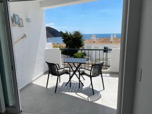 a patio with a table and chairs on a balcony at The Ocean View Luz in Luz
