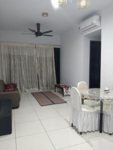 a living room with a table and a ceiling fan at The Valley, SkySierra KL in Kuala Lumpur