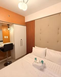 a bedroom with a bed with a desk and a sink at Cozy and Classy Monaco Suite Mt Arayat View in San Fernando