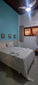 En eller flere senge i et værelse på Portal - praia taperapuan