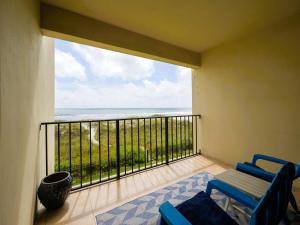 a balcony with two chairs and a view of the ocean at Sunkissed Escape in Jacksonville Beach +15 photos