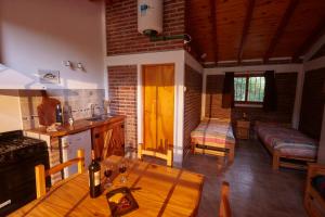 a kitchen with a wooden table in a room at Brisa del Bosque in El Bolsón