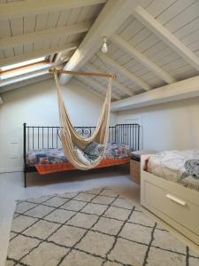 a hammock in a bedroom with two beds at Sotto Le Stelle Home - una Baita in città in Viterbo +3 photos