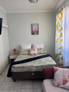 a bedroom with a bed and a couch at Flat in Khomas Region