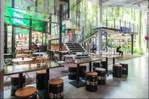 a restaurant with tables and chairs in a building at B & B Cozy Duplex Tamarind Square Cyberjaya in Cyberjaya