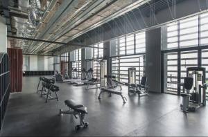 a large gym with several treadmills and machines at B & B Cozy Duplex Tamarind Square Cyberjaya in Cyberjaya