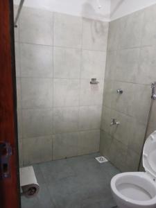 a bathroom with a shower and a toilet at A cozy spacious studio apartment with a balcony in Nairobi +30 photos