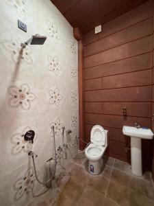 a bathroom with a toilet and a sink at Marwar Mosaic Heritage Haveli in Jodhpur +5 photos