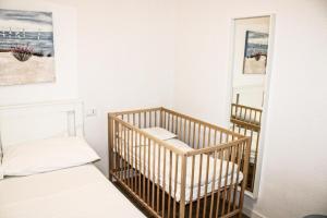een wieg in een kamer met een spiegel bij Mentana Guest House in Parma