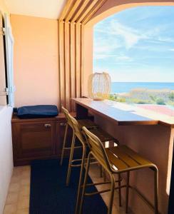 a room with a table and two chairs and a window at La Perle Marine in Fleury