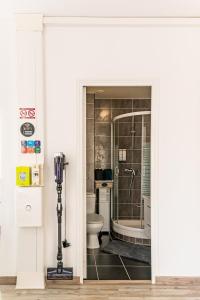 a bathroom with a toilet and a glass shower at Villa Mona Studio Galets quartier des Cordiers in Le Tréport